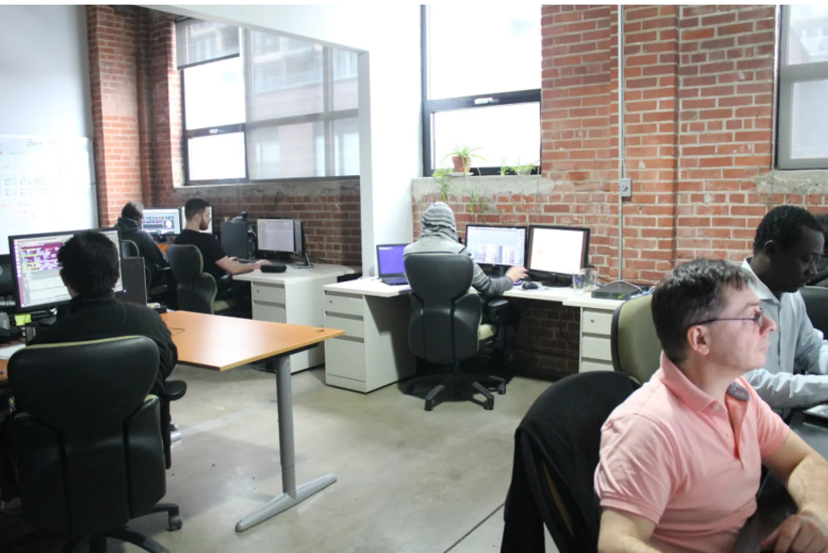 A team of developers working together at computers, collaborating on a project